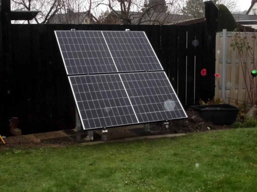 Aufgeständerte Photovoltaikmodule auf einer freien Gartenfläche. Das Beispiel zeigt eine Alternative, wenn geeignete Flächen außerhalb des Dachs genutzt werden sollen.